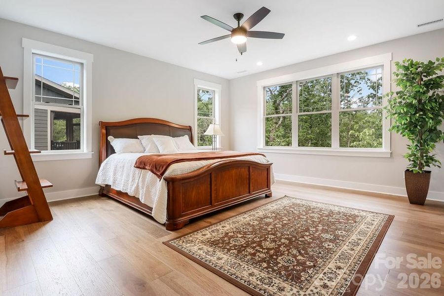 Primary suite features ceiling fans and lots of light and room for a king sized bed.