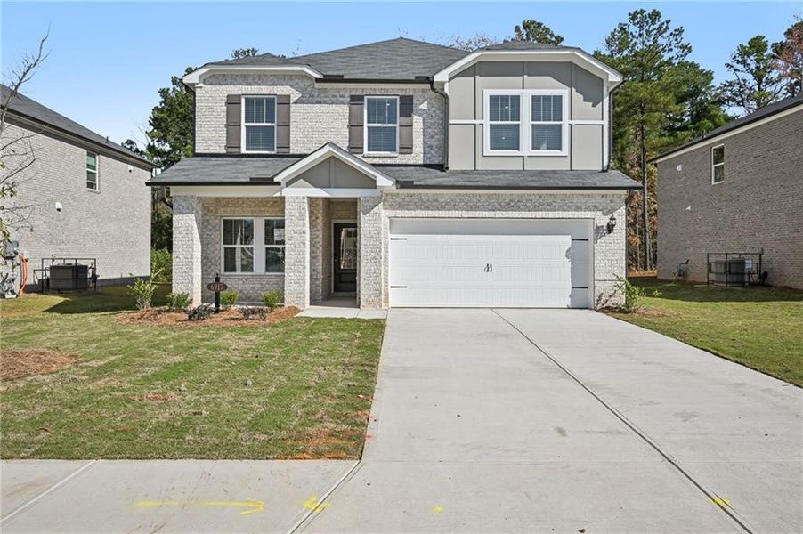 Front exterior of a new home in Creekside at Oxford Park, Fairburn, GA, highlighting curb appeal (Image 1).