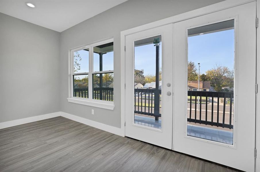 Doorway with hardwood / wood-style floors and french doors