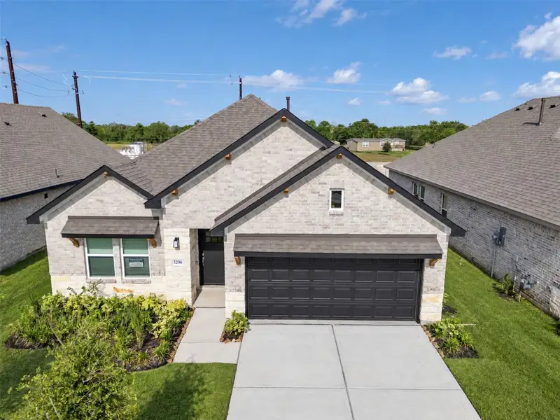 Front exterior of a new home in , Angleton, TX, highlighting curb appeal (Image 23).