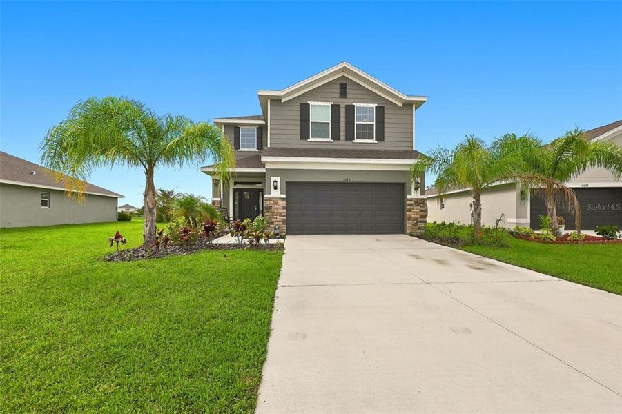 Front exterior of a new home in Aviary at Rutland Ranch, Parrish, FL, highlighting curb appeal (Image 2). Front exterior of a new home in Aviary at Rutland Ranch, Parrish, FL, highlighting curb appeal (Image 2).