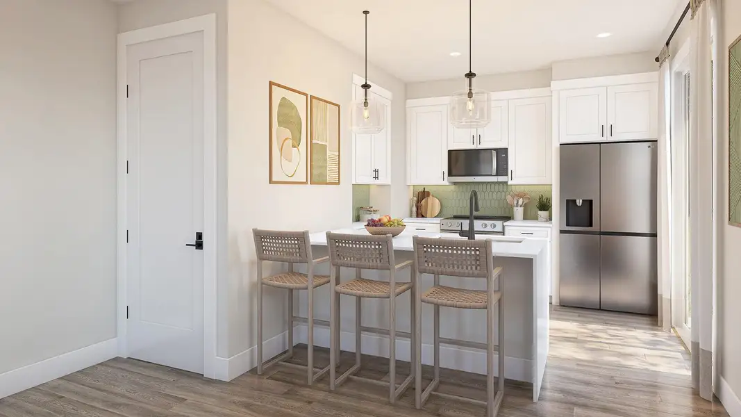 Kitchen featuring stainless steel appliances, a peninsula, white cabinets, a breakfast bar, and hanging light fixtures Kitchen featuring stainless steel appliances, a peninsula, white cabinets, a breakfast bar, and hanging light fixtures