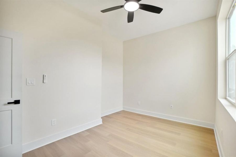 Spare room featuring ceiling fan and light wood-type flooring