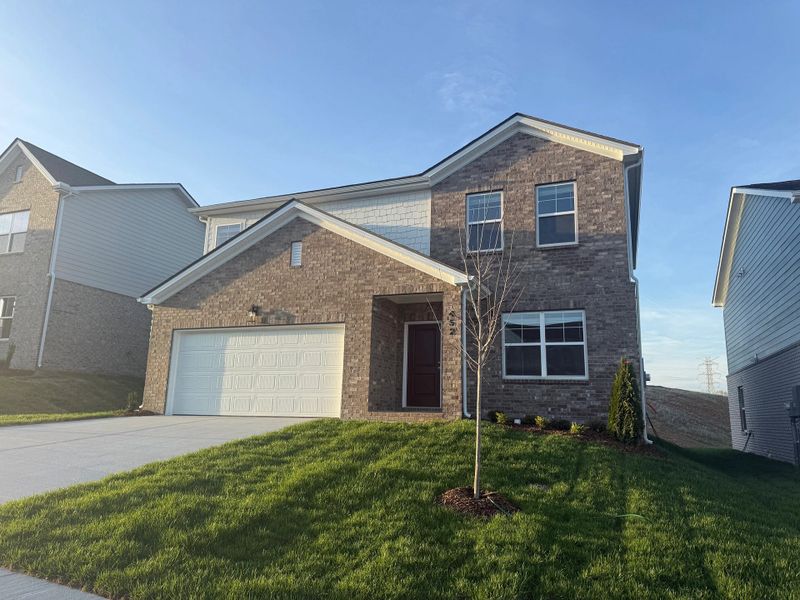 Front exterior of a new home in Cades Bluff, Lebanon, TN, highlighting curb appeal (Image 18).