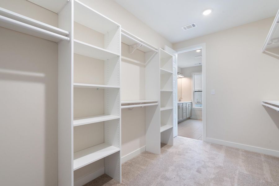 Integrated custom shelving, multiple hanging rods, and recessed lighting Integrated custom shelving, multiple hanging rods, and recessed lighting