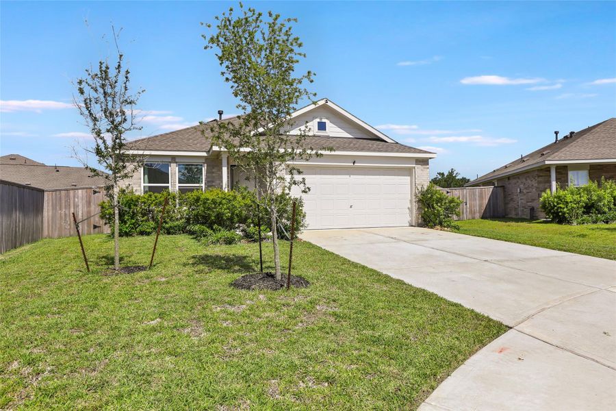 Front exterior of a new home in Tavola, New Caney, TX, highlighting curb appeal (Image 16).
