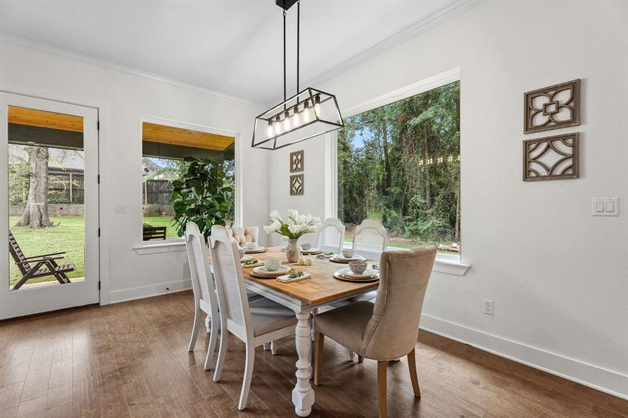 Dining area featuring hardwood / wood-style floors and crown molding Dining area featuring hardwood / wood-style floors and crown molding