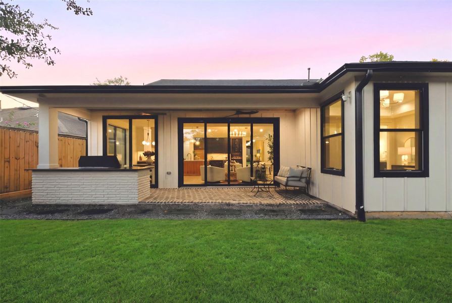 Backyard entertaining is made easy with a fully equipped outdoor kitchen and covered patio.