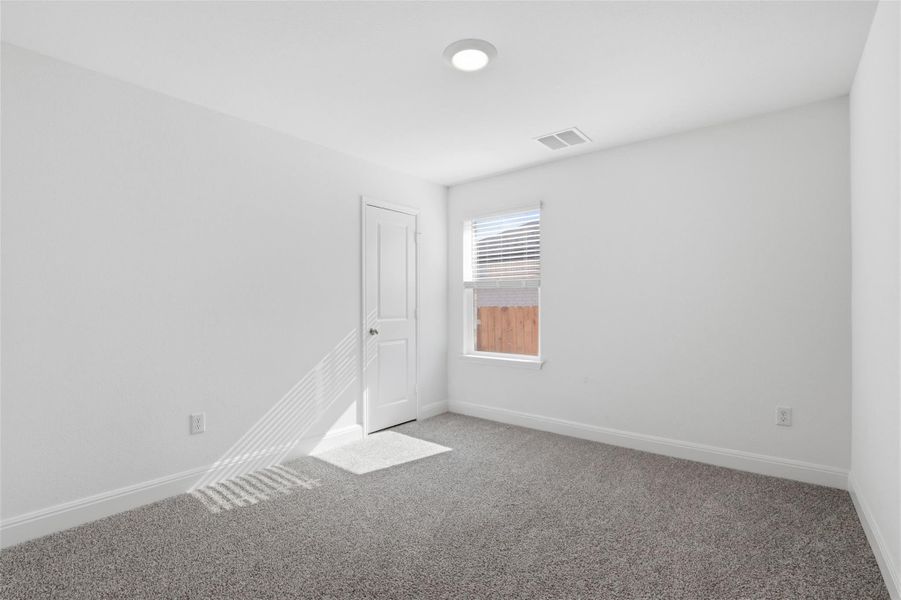 Room featuring neutral gray carpeting and white painted walls