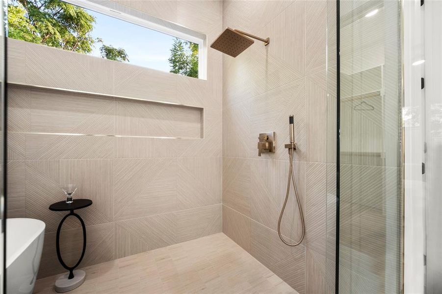 Bathroom with tile walls and tiled shower