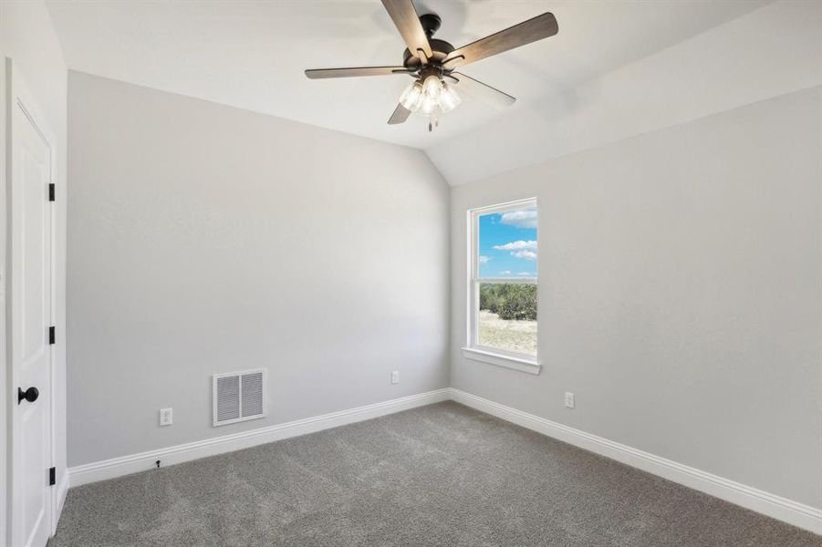 Unfurnished room with carpet floors, ceiling fan, and lofted ceiling