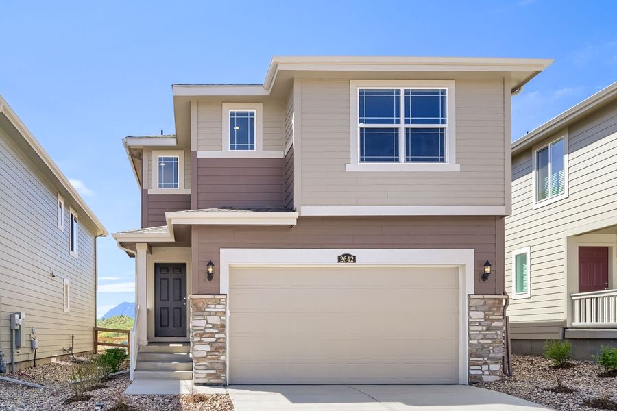 Front exterior of a new home in Preserve at Mesa Creek, Colorado Springs, CO, highlighting curb appeal (Image 1). Front exterior of a new home in Preserve at Mesa Creek, Colorado Springs, CO, highlighting curb appeal (Image 1).