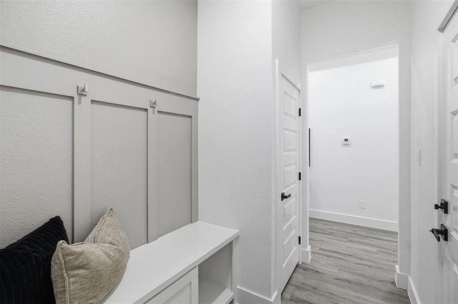 Built-in entryway bench with integrated storage and board-and-batten accent wall