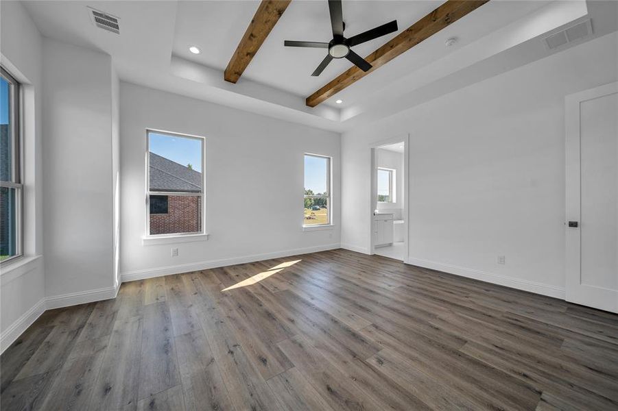 Spare room featuring wood finished floors, beam ceiling, ceiling fan, and recessed lighting