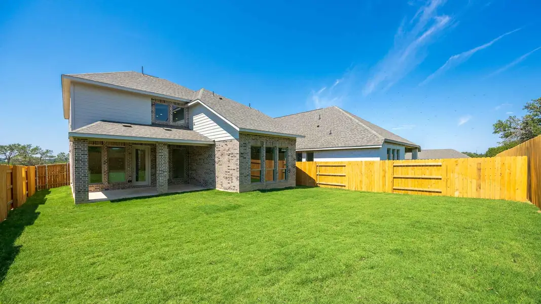 Front exterior of a new home in Woodside 47', Georgetown, TX, highlighting curb appeal (Image 2).