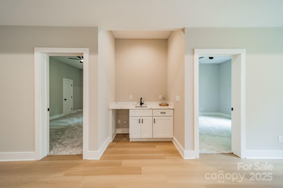 A stunning, secondary Wet Bar with ice maker (now installed) for entertaining in the Living Room of the Lower Level