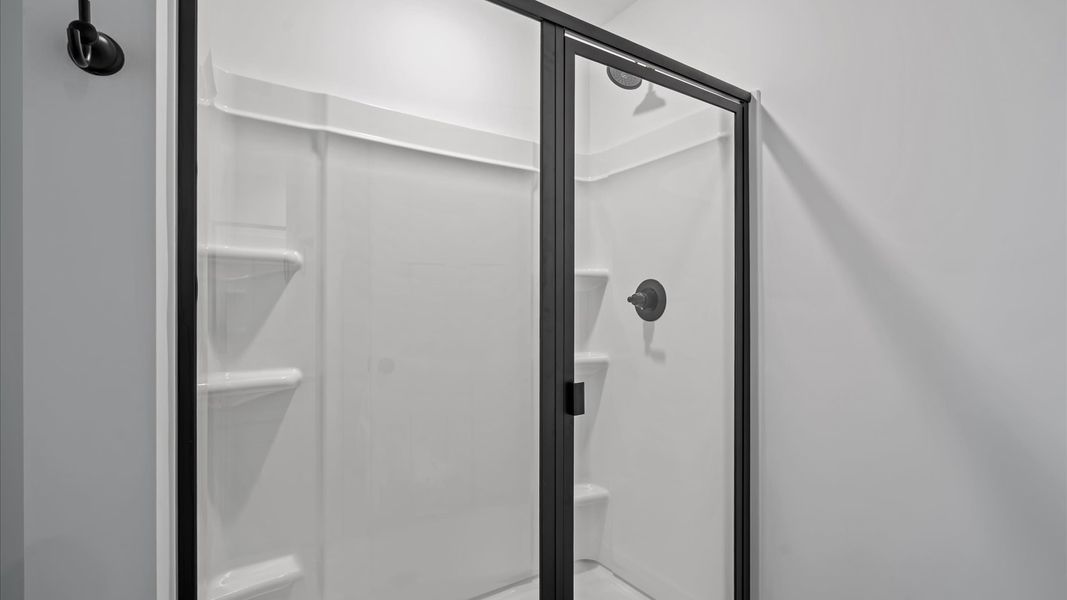 Exceptional en-suite with dual vanity and glass-enclosed walk-in shower for superior everyday comfort