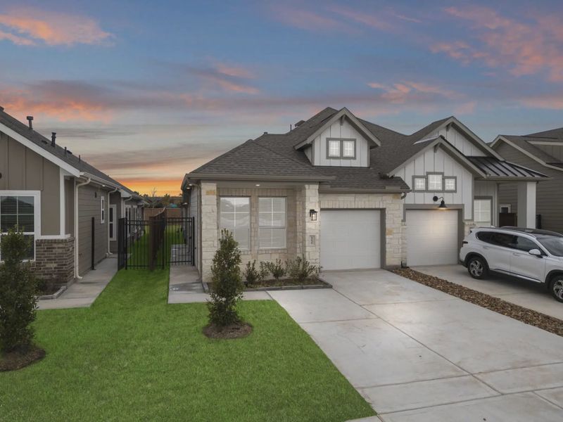 Representative exterior photo of a completed home built from the Carriagehouse by Chesmar Homes in Meridiana Townhomes, Iowa Colony, TX (Image 37).
