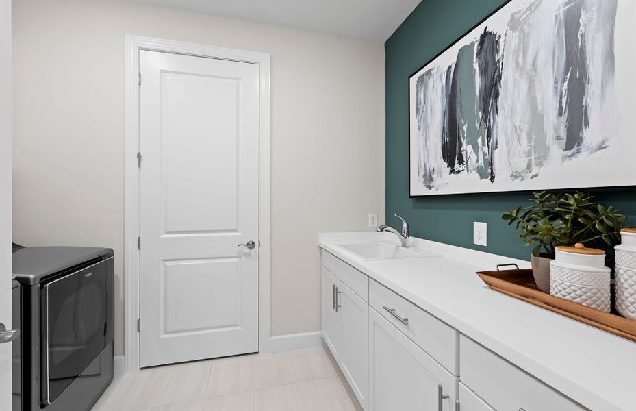 Spacious laundry room with extra storage space and Spacious laundry room with extra storage space and