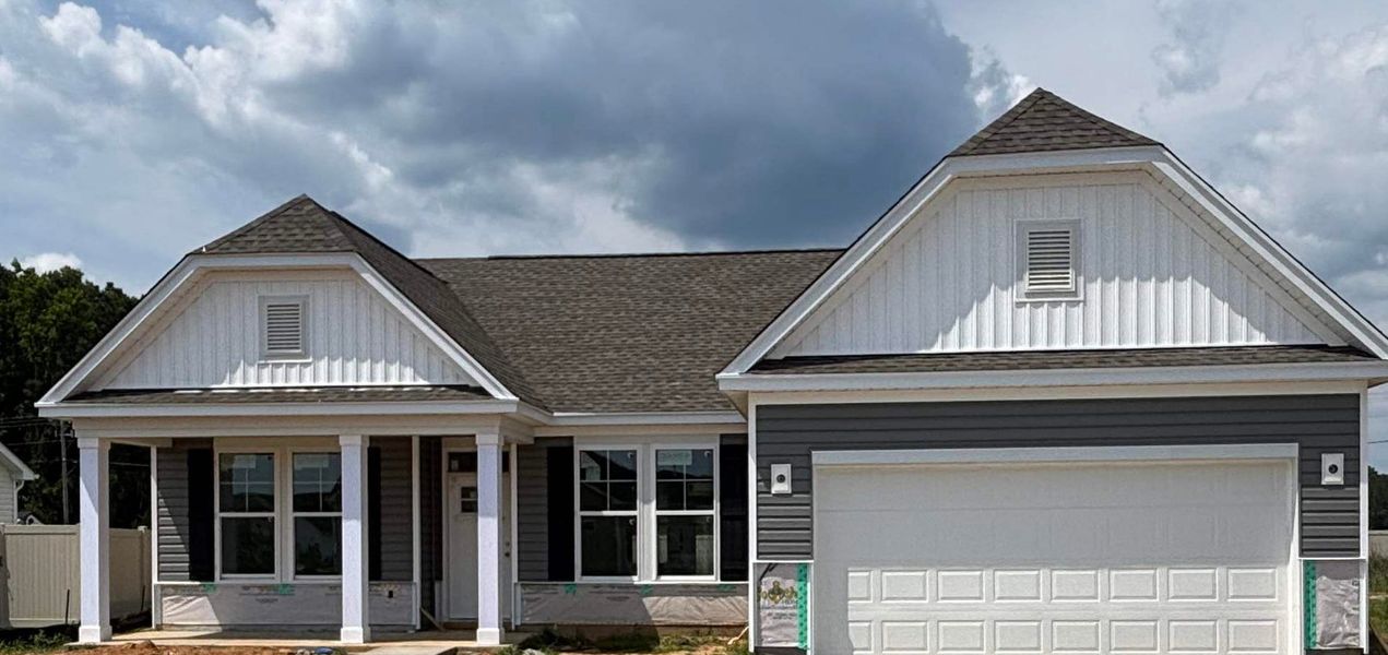 Front exterior of a new home in Avery Woods, Longs, SC, highlighting curb appeal (Image 1). Front exterior of a new home in Avery Woods, Longs, SC, highlighting curb appeal (Image 1).