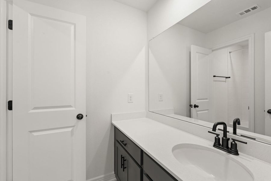 The secondary bath features tile flooring, white cabinetry and light countertops and a shower/tub combo. Perfect for accommodating any visiting family and friends. The secondary bath features tile flooring, white cabinetry and light countertops and a shower/tub combo. Perfect for accommodating any visiting family and friends.