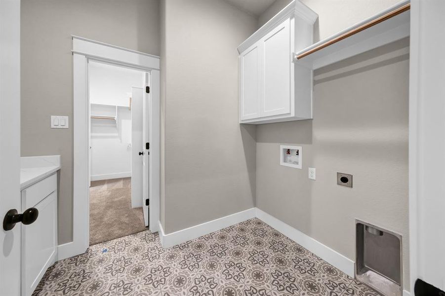 Laundry room featuring cabinets, washer hookup, light tile floors, and hookup for an electric dryer