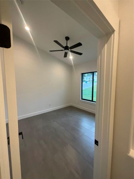 Empty room with baseboards and a ceiling fan Empty room with baseboards and a ceiling fan
