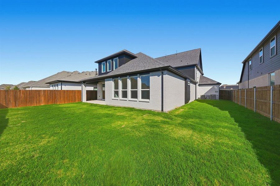 Back of property featuring a patio, brick siding, a fenced backyard, and roof with shingles Back of property featuring a patio, brick siding, a fenced backyard, and roof with shingles