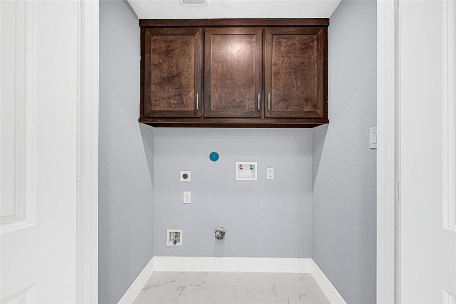 Extra cabinet space in utility closet, electric and gas connection available for dryer.