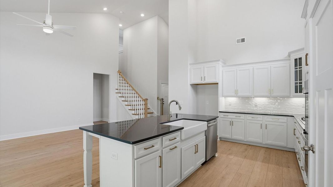 Exceptional kitchen featuring a spacious island, eye-catching features, and modern finishes at Pelham Crossing