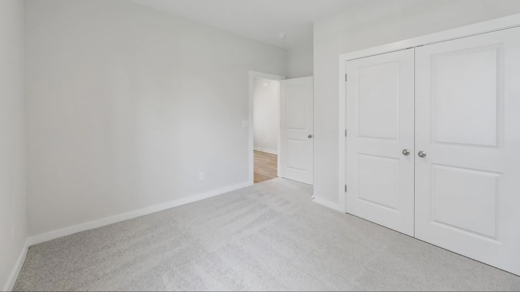 Bedroom with carpet and closet