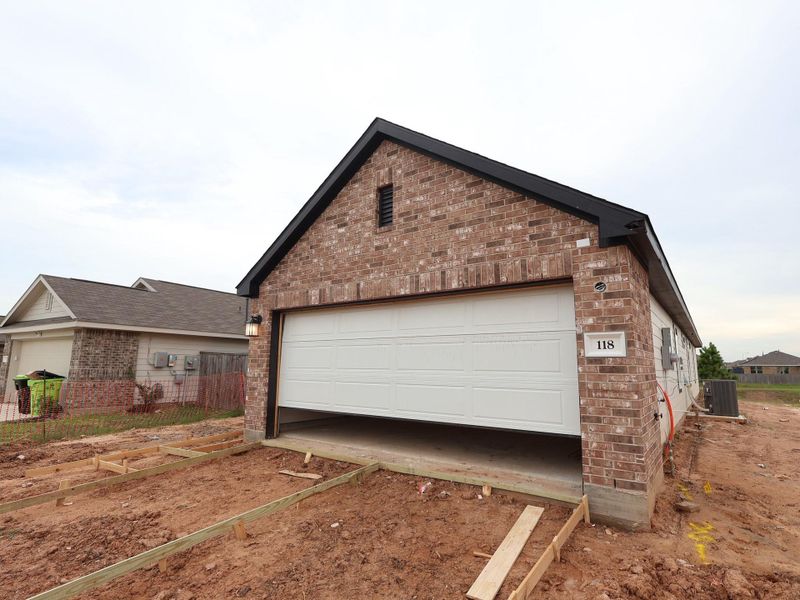 Front exterior of a new home in Magnolia Ridge, Magnolia, TX, highlighting curb appeal (Image 20). Front exterior of a new home in Magnolia Ridge, Magnolia, TX, highlighting curb appeal (Image 20).
