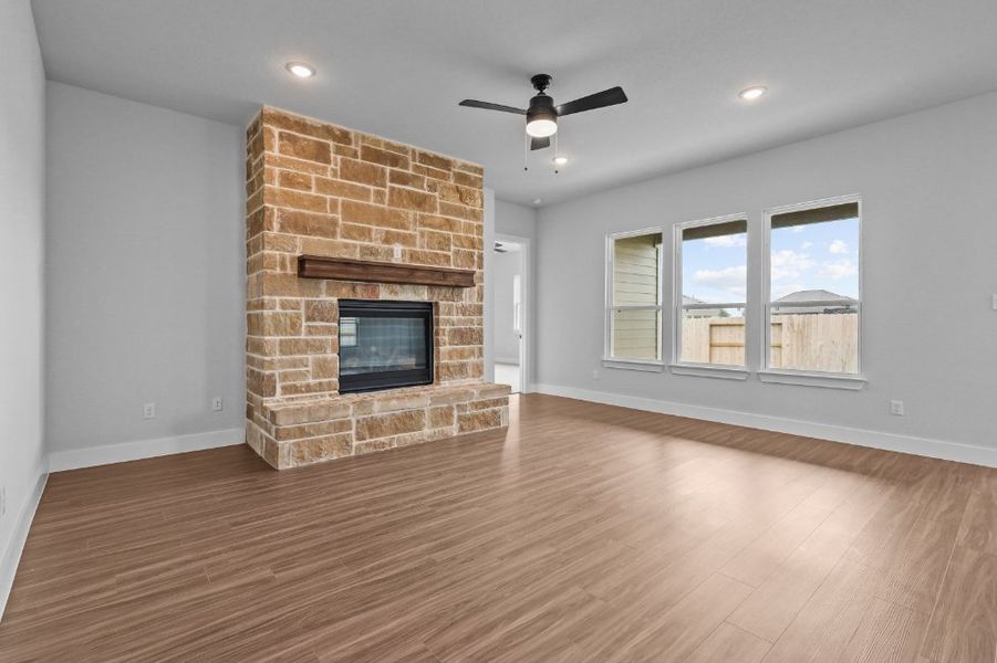 A room with a fireplace and a wood floor. A room with a fireplace and a wood floor.