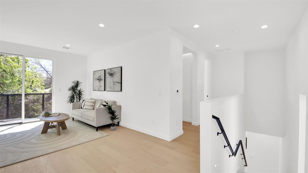 Upstairs game room/living area featuring recessed lighting, light wood finished floors, and an upstairs landing