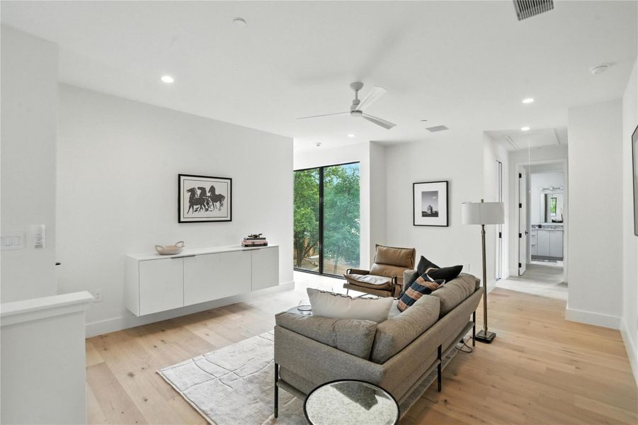 Living room with attic access, light wood-style floors, ceiling fan, and recessed lighting Living room with attic access, light wood-style floors, ceiling fan, and recessed lighting
