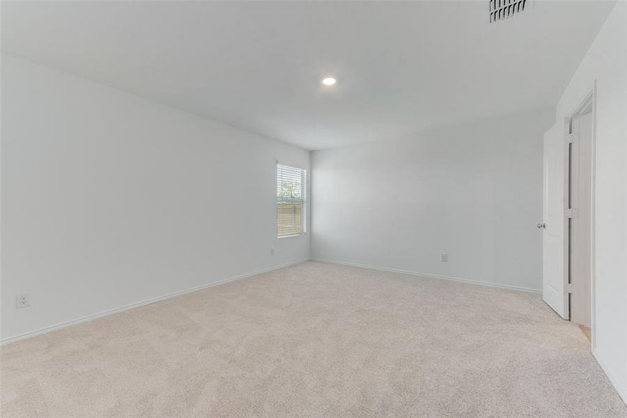 Empty room featuring light colored carpet