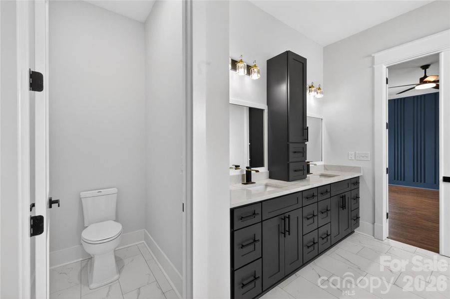 A private water closet, double vanity, and enough cabinet storage to finally keep countertops clean and organized
