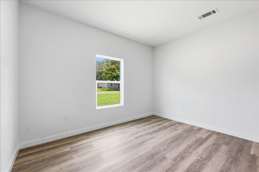 View highlighting the large window overlooking the side yard from this bedroom. View highlighting the large window overlooking the side yard from this bedroom.