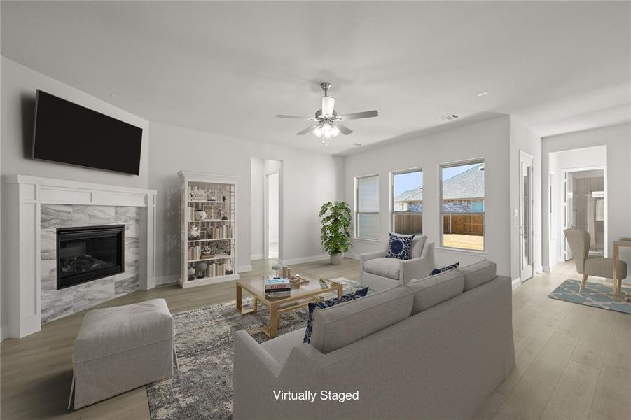 Spacious family room with plenty of natural light, cozy seating, and a welcoming atmosphere—perfect for watching your favorite game shows or cheering on your team during the big game.