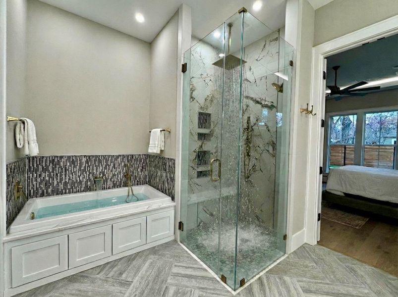 Bathroom with connected bathroom, a marble finish shower, a bath, recessed lighting, and ceiling fan