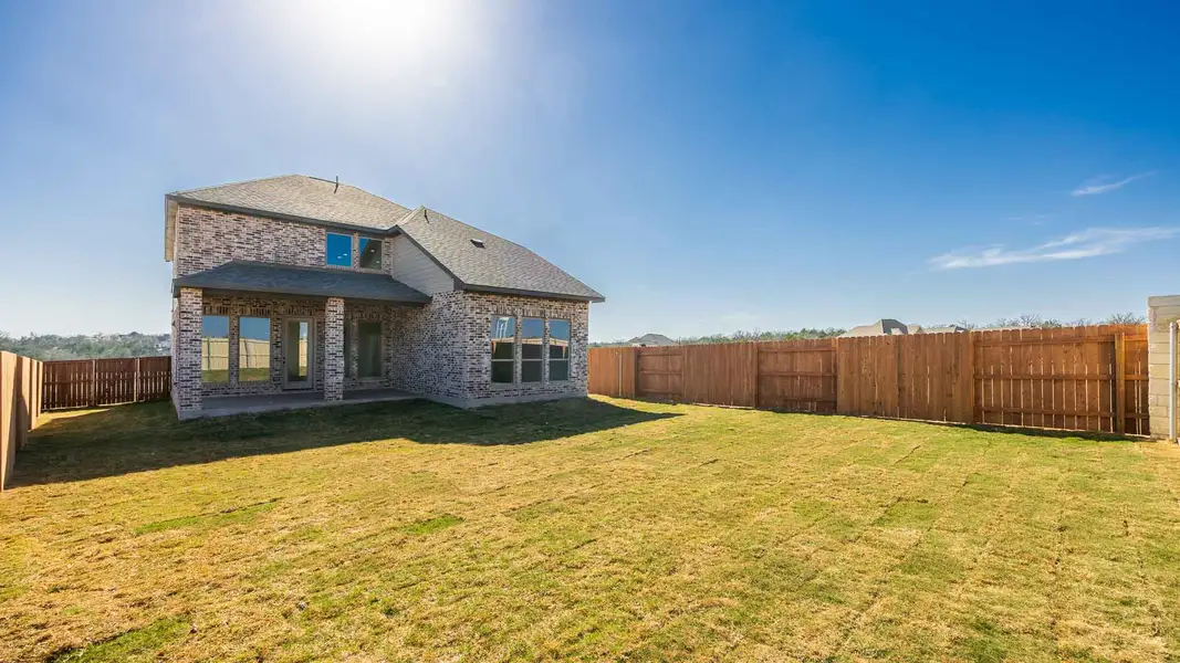 Exterior details and patio area of a home in The Colony, Bastrop (Image 2).