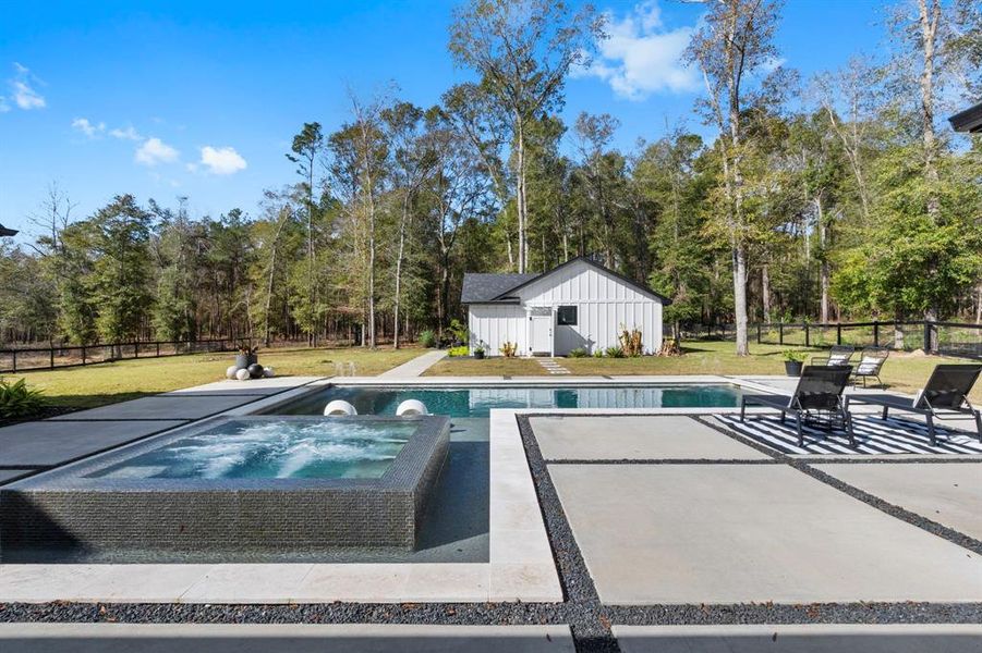 This stunning custom designed pool is one of kind space. Equipped with a hot tub, Beach sitting area, and luxury features unseen.