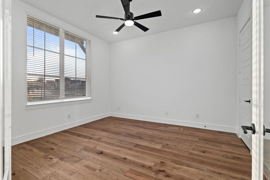 Unfurnished bedroom with dark wood-type flooring, ceiling fan, and recessed lighting Unfurnished bedroom with dark wood-type flooring, ceiling fan, and recessed lighting