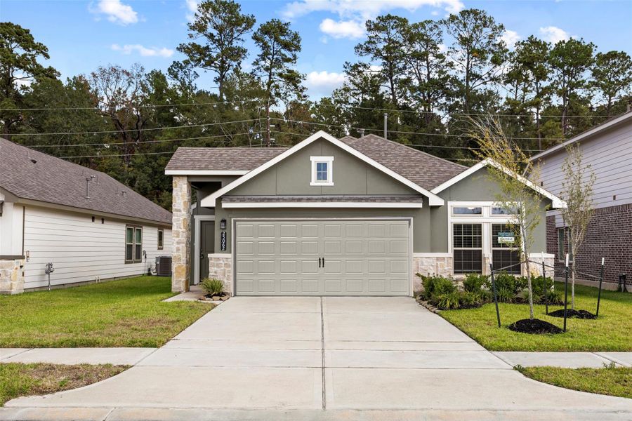 Front exterior of a new home in Enclave at Dobbin, Magnolia, TX, highlighting curb appeal (Image 2). Front exterior of a new home in Enclave at Dobbin, Magnolia, TX, highlighting curb appeal (Image 2).