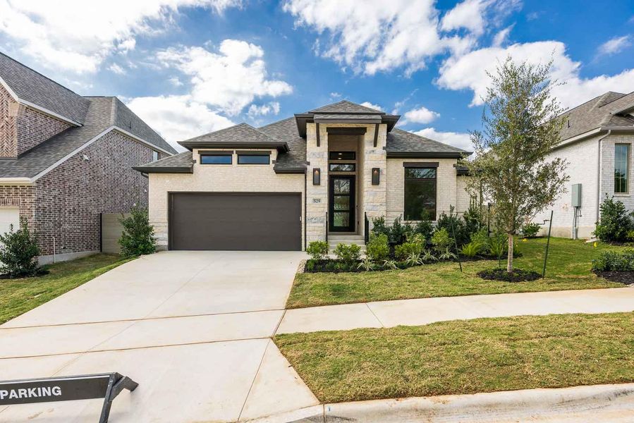 Front exterior of a new home in Wolf Ranch 51', Georgetown, TX, highlighting curb appeal (Image 17).