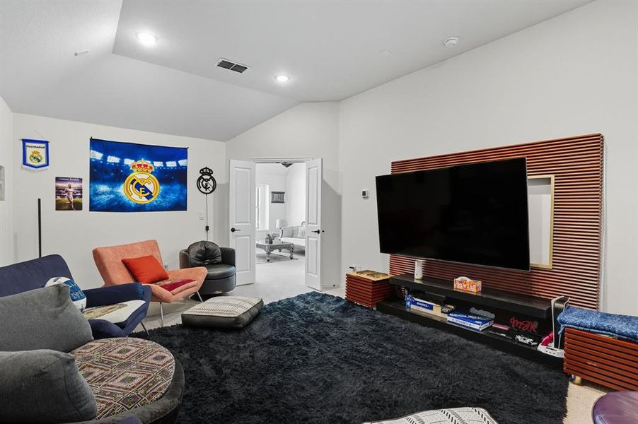 Living room featuring carpet floors and lofted ceiling