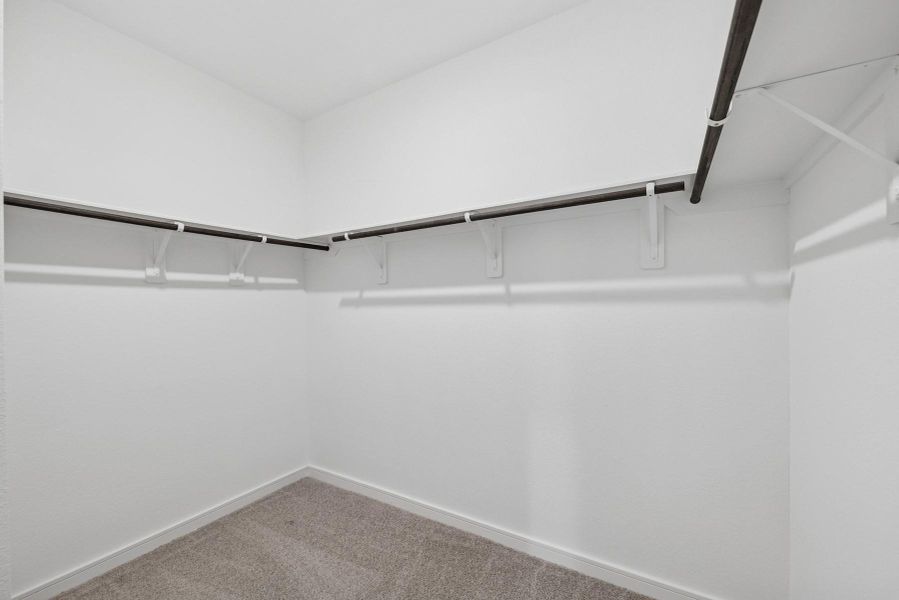 Walk-in closet in the primary suite (*Photo not of actual home and used for illustration purposes only.) Walk-in closet in the primary suite (*Photo not of actual home and used for illustration purposes only.)