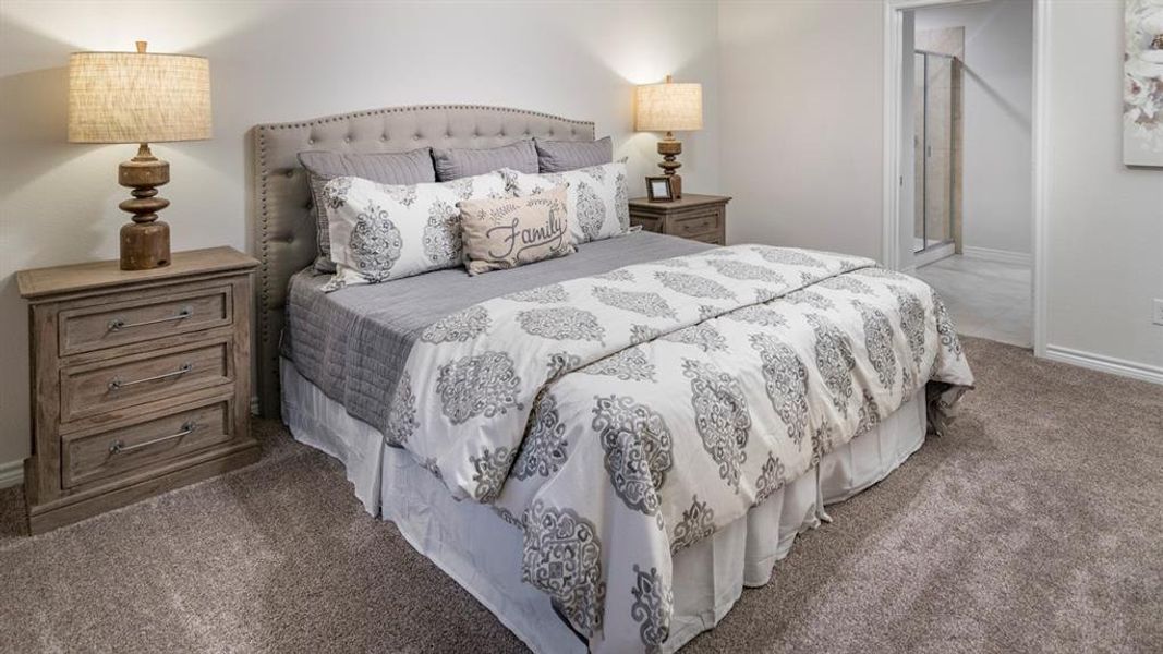 Bedroom featuring carpet floors and connected bathroom Bedroom featuring carpet floors and connected bathroom