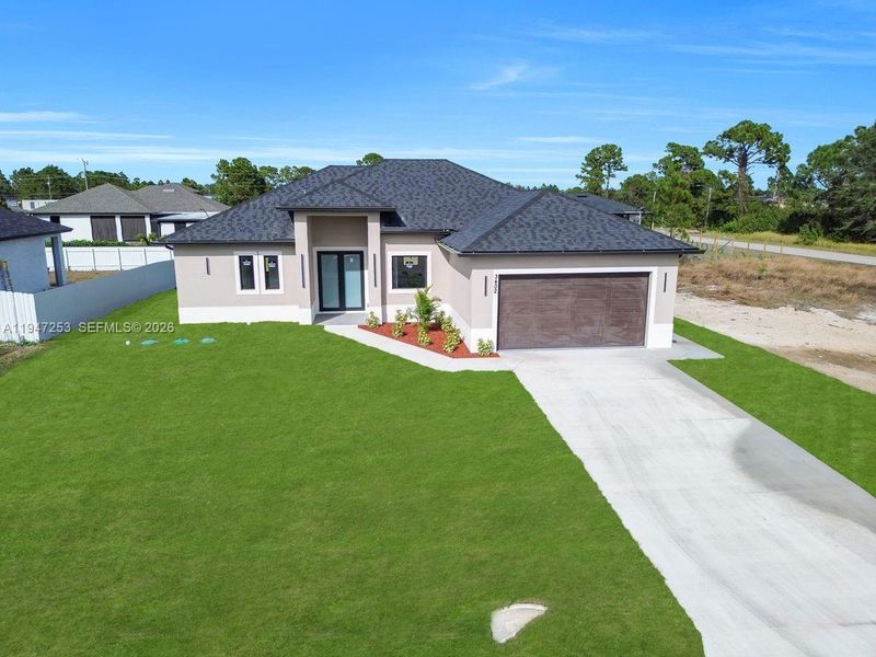 Front exterior of a new home in , Lehigh Acres, FL, highlighting curb appeal (Image 19).
