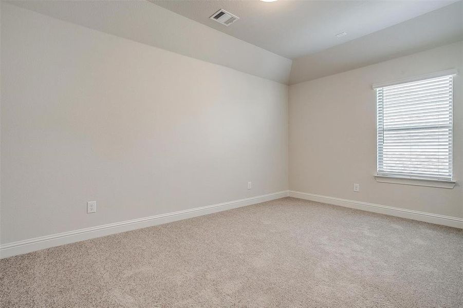 Spare room featuring carpet flooring